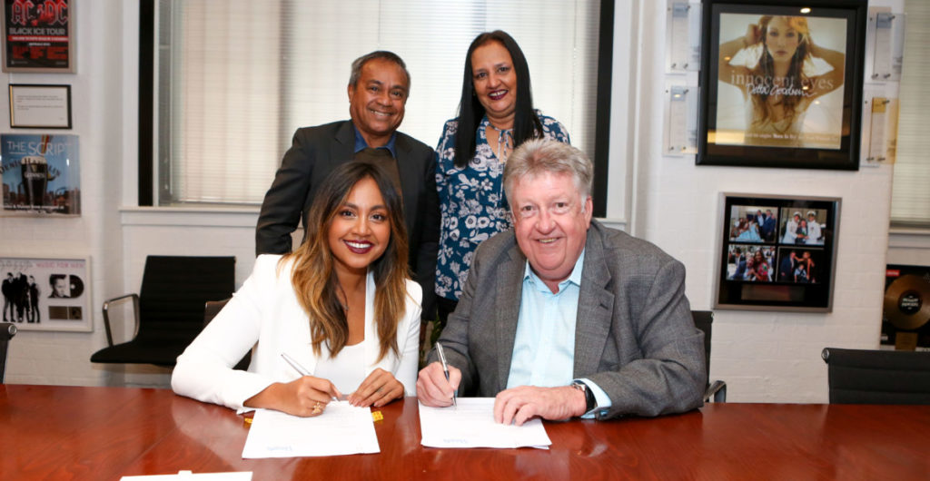Jessica Mauboy signing her Parade Management contract with Denis Handlin, joined by her parents Therese and Ferdy Mauboy